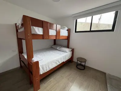 a bedroom with two bunk beds and a window at Casa de Playa de Estreno in San Antonio