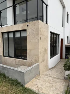 a house with glass windows on the side of it at Casa de Playa de Estreno in San Antonio