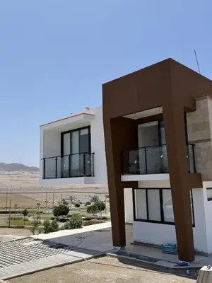a building in the desert with a large building at Casa de Playa de Estreno in San Antonio
