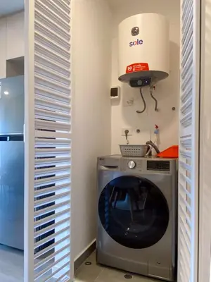 a kitchen with a washing machine in a room at Enchanting Loft with Balcony in Barranco in Lima