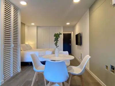 a room with a table and chairs and a bed at Enchanting Loft with Balcony in Barranco in Lima