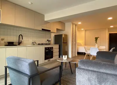 a kitchen and living room with a couch and a table at Enchanting Loft with Balcony in Barranco in Lima