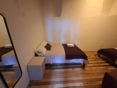 a bedroom with a bed in a room at Acogedor Departamento Vitoque in Cusco