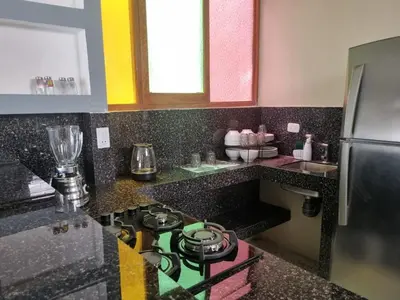 a kitchen with a stove and a refrigerator at Departamento en Ica super céntrico en Urb San Miguel in Ica