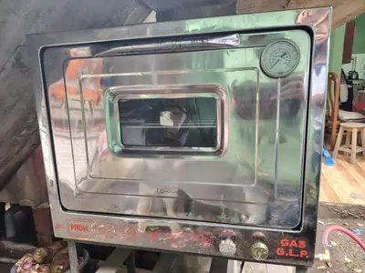 a metal oven with a window on top of it at Posada del Carmen in Quillabamba