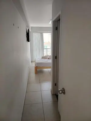 a hallway with a room with a bed and a door at San bartolo 2 in San Bartolo