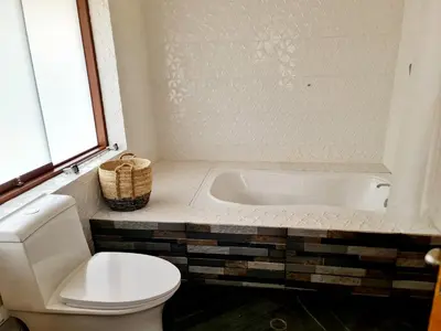 a bathroom with a toilet and a bath tub at Beautiful house in the Sacred Valley, Arin Falls in Calca