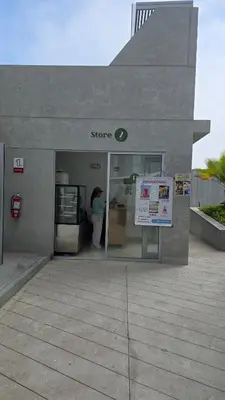a store with a woman standing outside of it at Exclusive apartment in San Bartolo in San Bartolo