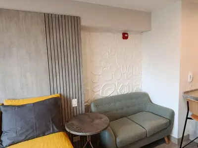 a living room with a couch and a table at JAVIER PRADO ESTE 1501 LOFT- FRENTE a SAN BORJA in Lima