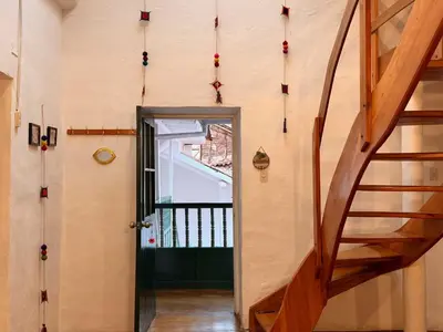 a hallway with a staircase and a door with christmas decorations at Andes Home in Cusco