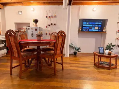 a dining room table and chairs in a kitchen at Andes Home in Cusco