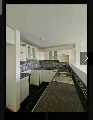 an empty kitchen with white cabinets and a sink at Modern Apartament Pool & Jacuzzi 1 room in Lima