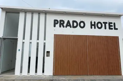 a facade of araxo hotel with a red door at Prado hotel in Chancay