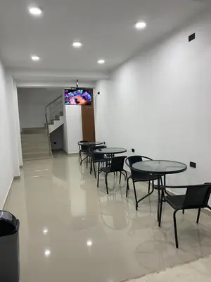 a dining room with tables and chairs and a television at Prado hotel in Chancay