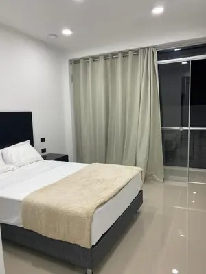 a bedroom with a bed and a glass shower at Prado hotel in Chancay