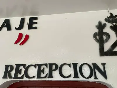 a sign for a restaurant with red peppers on it at HOSPEDAJE VISTA DEL SOl PARACAS in Paracas