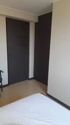 a bedroom with black doors and a white bed at Hotel Naciones Unidas in Lima