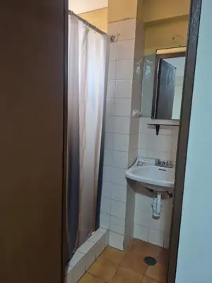a bathroom with a shower and a sink at Hotel Naciones Unidas in Lima