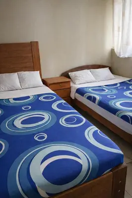 two beds sitting next to each other in a bedroom at Central 3 minutes from Plaza de Armas by car in Quillabamba