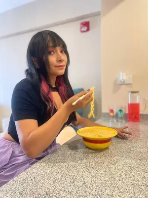 a woman sitting on the floor eating a piece of food at Anime-Style Studio Decor in Lima