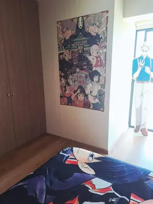 a bedroom with a blanket on the floor with a poster at Anime-Style Studio Decor in Lima