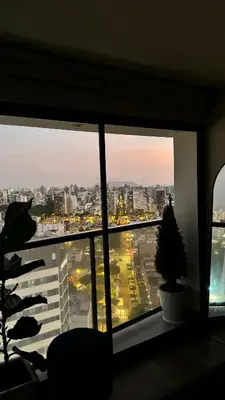 a window in a room with a view of a city at Salaverry Luxury Apartment in Lima