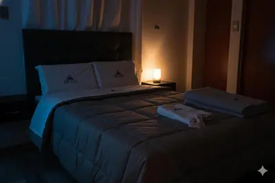 a bedroom with a large bed with towels on it at Hostal New York in Jauja