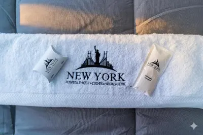 two toothbrushes sitting on top of a white towel at Hostal New York in Jauja