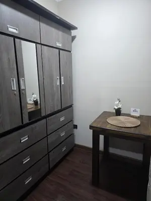 a bathroom with a vanity and a table with a sink at room rent in Lima