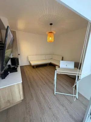 a room with a couch and a table with a laptop at Departamento con vista al Mar in San Bartolo
