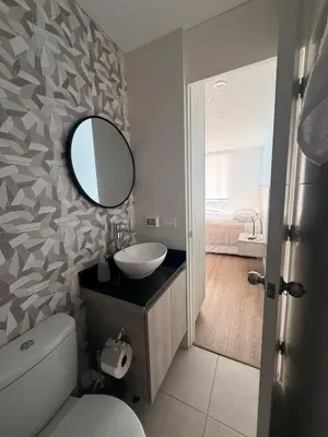 a bathroom with a sink and a mirror at Departamento con vista al Mar in San Bartolo
