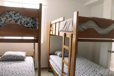 two bunk beds in a small room with another bed at Increible casa de playa con vista al lago in San Vicente de Cañete