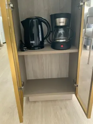 a cabinet with a coffee maker and a blender on it at Modern apartment in Larco 791 in Lima