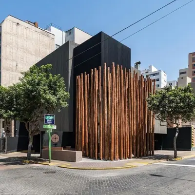 a building with a fence made out of logs at Modern apartment in Larco 791 in Lima