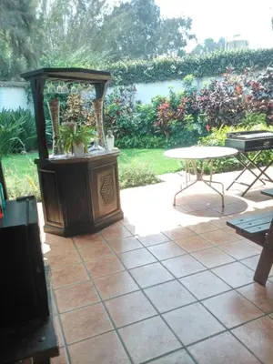 a patio with a table and a table and a table and a table at Nice country house with a swimming pool and large garden in Cieneguilla