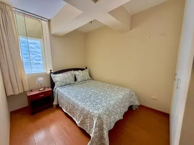 a small bedroom with a bed and a window at Casa de Liz in Lima