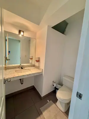 a bathroom with a toilet and a sink and a mirror at Casa de Liz in Lima