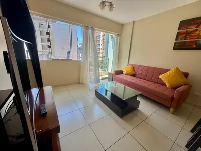 a living room with a red couch and a glass table at Casa de Liz in Lima