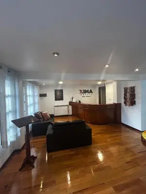 a living room with a couch and a piano at Xima Cusco Kenamari in Cusco