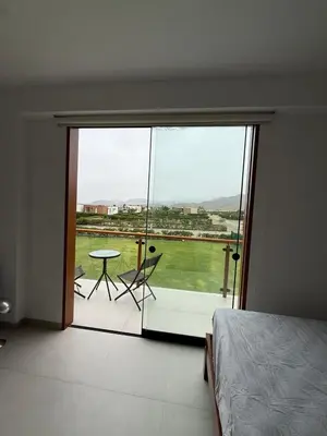a bedroom with a large glass door leading to a patio at House 3M in Condominium Fundo Pradera, Chocaya - Lima - Perú in Asia