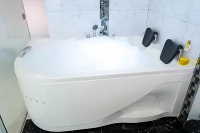 a white toilet in a bathroom with a sink at Solay Inn in Ayacucho