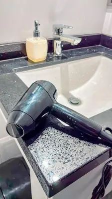 a blow dryer sitting in a drawer next to a sink at Departamento Illapa in Cusco
