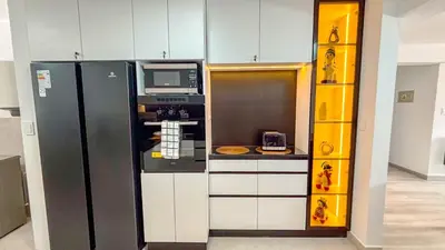 a kitchen with a black refrigerator and a microwave at Departamento Illapa in Cusco