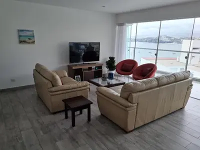 a living room with two couches and a table at Duplex - Playa Embajadores in Quebrada Seca