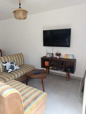 a living room with two couches and a flat screen tv at Vacaciones sin Estres, ambiente relajado y familiar in San Antonio