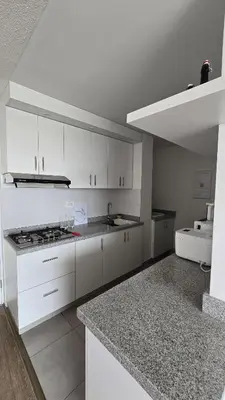 a white kitchen with a sink and a stove at Departamento exclusivo en San Bartolo in San Bartolo