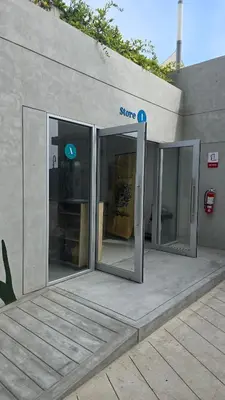 an entrance to a store with two sliding glass doors at Departamento exclusivo en San Bartolo in San Bartolo
