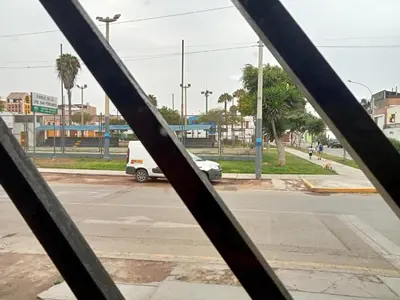 a view of a street through a metal fence at Departamento 2 dormitorios 4B in Lima