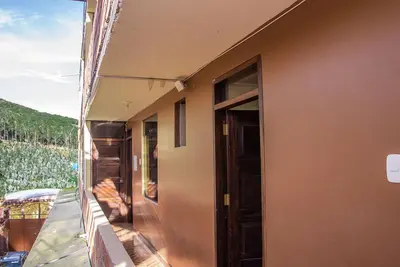 a balcony of a house with a view of a valley at Departamentos Santa Ana Barrio Tradicional in Cusco