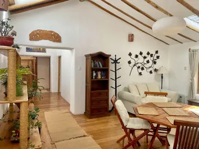 a living room with a table and a couch at Kusi Qente in Cusco